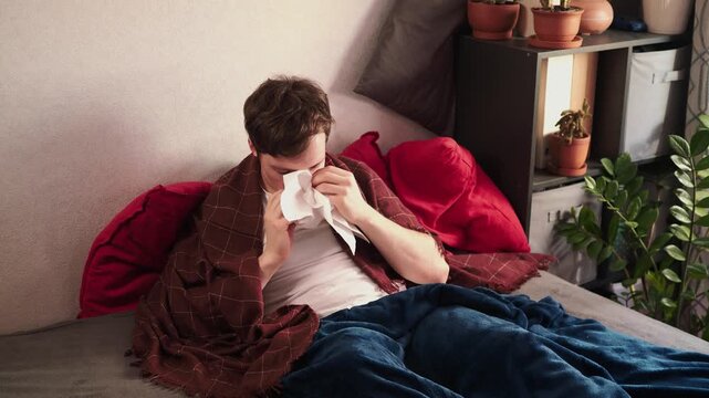 Guy feeling cold at home with home heating trouble. 