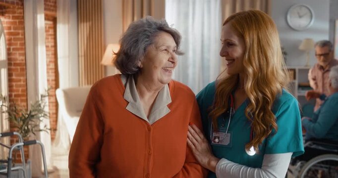 Smiling caregiver and elderly woman sharing warm look in assisted living home. Portrait capturing happiness, trust and emotional connection in friendly, supportive environment indoors.