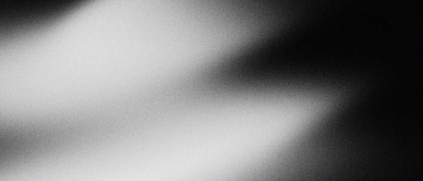 Abstract grainy gradient background with soft light leaks, dark cinematic film grain texture with blurry white highlights, moody monochrome overlay for creative photography and web design