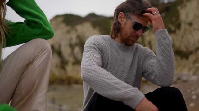 Woman in green sweatshirt gazes at distant landscape on a cloudy day