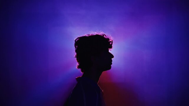 silhouette of a young man with headphones