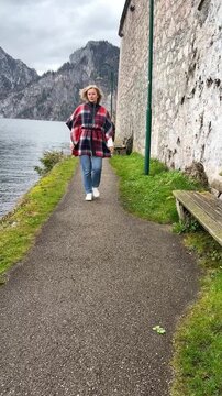 Woman walking lakeside in Traunkirchen Ausria
