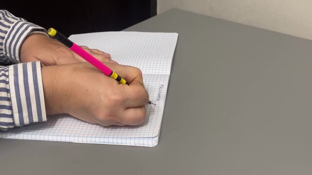 The graphite lead of a wooden pencil breaking snapping