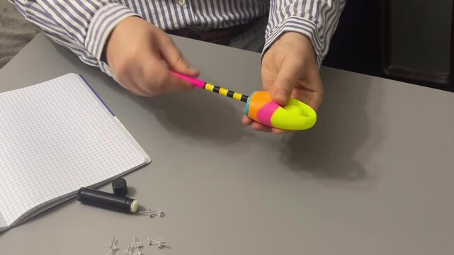 A wooden pencil sharpening with a sharpener, cracking