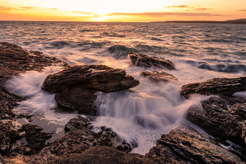 Obraz premium Sunset and waves at Trearddur Bay Anglesey 