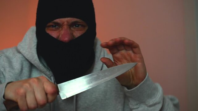 A dangerous criminal with a sharp knife threatens to kill the victim.
Danger to life, fear of a criminal with a gun in hand.
Police flashing light.