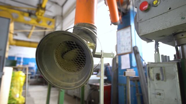 The smoke extraction system operates in a factory environment to ensure worker safety and air quality control.
