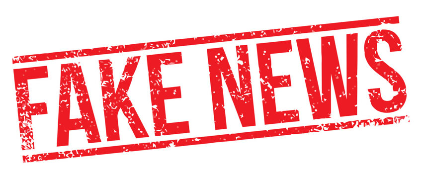 A close-up view of a red stamp reading Fake News on a white surface with bold letters.