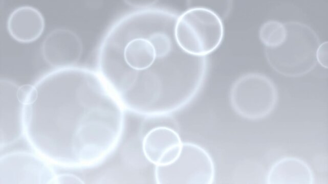 Soft glowing bokeh circles on a light background. Ideal for creating a dreamy atmosphere in videos and presentations