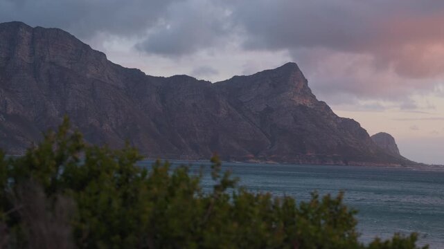 Sunset at Kogel Bay with Purple and Blue Clouds Flowing Over Mountains, Cinematic Coastal Landscape in South Africa
