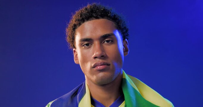 African American man tilting head, yellow-green flag sliding on shoulders in studio showing support