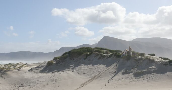 teens and children sand boarding dunes, Walker Bay Nature Reserve, Stanford, South Africa