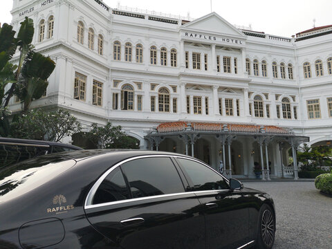 Raffles Hotel Singapore iconic luxury heritage landmark with chauffeured Maybach limousine, showcasing premium hospitality, travel, and upscale lifestyle in a historic setting