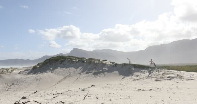 teens and children sand boarding dunes, Walker Bay Nature Reserve, Stanford, South Africa