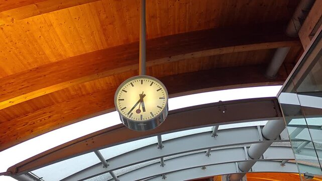 Large Swiss Station Clock Hanging from Wooden Ceiling in Bern Train Station