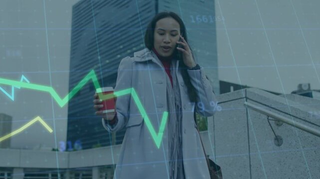 Woman receiving call and descending stairs in plaza to continue call, finance graphs tracking data