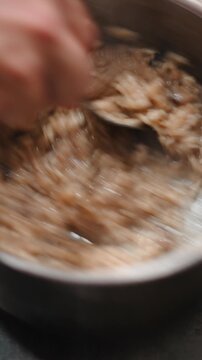 Close up of a chef stirring creamy italian risotto with chestnut puree in a pot