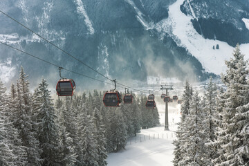 Cold winter day alpine slope ski snowboard Kohlmaisbahn gondola station lift. Saalbach-Hinterglemm ski circus panorama resort. Winter frosted mountain slopes cold air travel mood scenic silence © Kyryl Gorlov