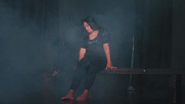 Contemplative Woman in Smoky Atmosphere