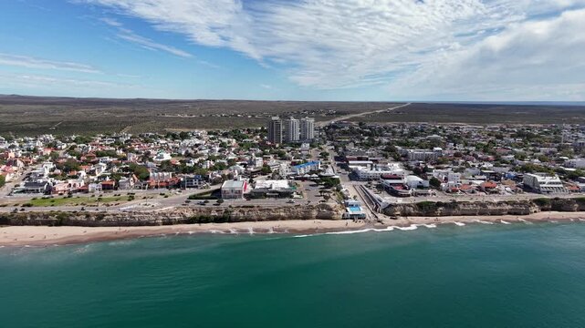 Panoramic drone shot of Las Grutas city and the Atlantic Ocean coastline.