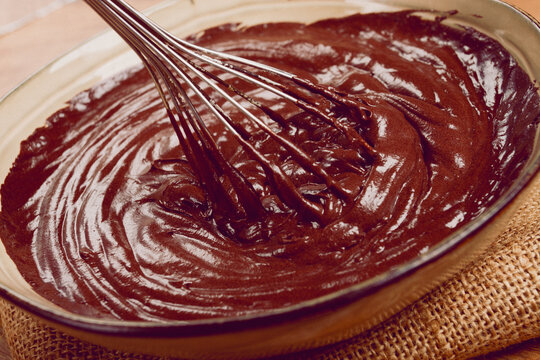a bowl of chocolate dough, a whisk for whipping, baking, structure and consistency, homemade, top view, no people,