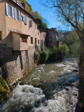 Old riverside houses along a river in Foix France