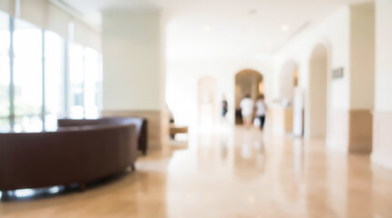 Fototapeta premium Blurry image of a modern lobby with brown furniture and large windows