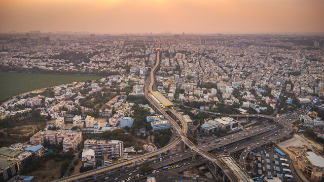 Aerial view of Bangalore urban infrastructure featuring metro line, highways and dense city development