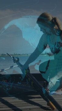 Vertical video: Rower kneeling dock grasping oar, adjusting rigger, checking fit with globe overlay