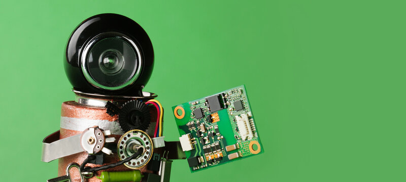 Robot it specialist waist‑up, black helmet, holding pcb with microchips, green backdrop text placeholder. Computer hardware flyer, semiconductor leaflet, digital development card