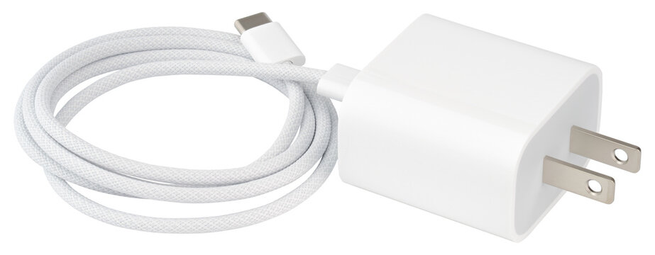 USB-C charger. Fast charging power adapter with USB Type-C cable portable wall charger for smartphone tablet laptop and electronic devices. Electricity supply concept. Isolated background