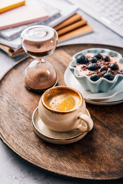 Small coffee breat with fresh jogurt with blueberries at desk, lunch in a office