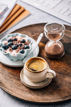Small coffee breat with fresh jogurt with blueberries at desk, lunch in a office