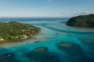 Fototapeta premium Aerial view of a serene tropical island with crystal clear waters and lush greenery