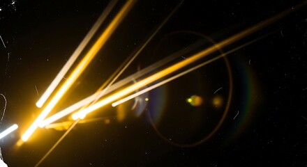 Obraz premium Abstract golden light streaks and lens flare effect captured against a deep black textured background