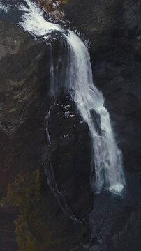 Epic Waterfall in scenic iceland nature, aerial shot - vertical video