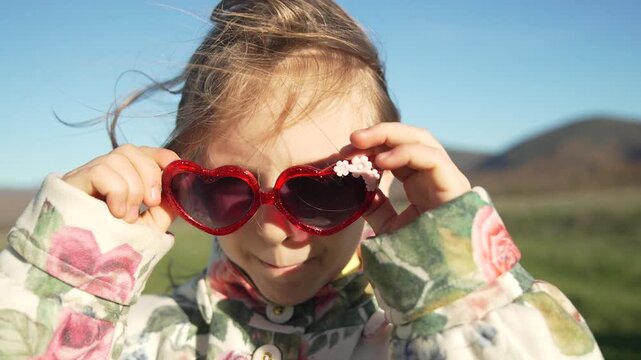 Playful Child Fun Goofy girl making silly faces outdoors in the sunshine