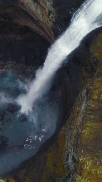 Epic Waterfall in scenic iceland nature, aerial shot - vertical video