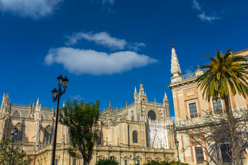 Fototapeta premium Seville, Andalusia, Spain, a stunning view of the historic cathedral and adjacent architecture under a bright blue sky, showcasing gothic details and a vibrant city scene on Feb 13, 2020