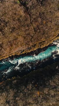 Epic Waterfall in scenic iceland nature, aerial shot - vertical video