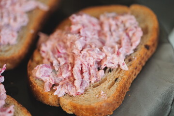 Obraz premium A close-up shot of a slice of bread topped with meat, ideal for use in food or restaurant context