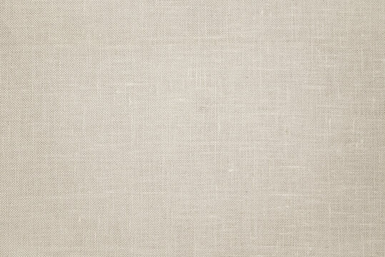 Linen fabric texture background in neutral beige color. Light beige textile background for packaging, design, banner and copy space.