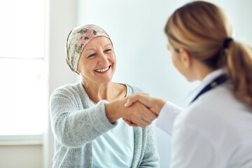 Obraz premium Happy Senior Cancer Patient Shaking Hands with Her Female Doctor