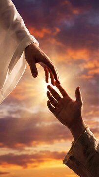 Two hands reach towards each other against a dramatic sunset sky with warm, glowing clouds. Hand dressed in white symbolizes divine touch, the other in earthy tones represents human connection or help
