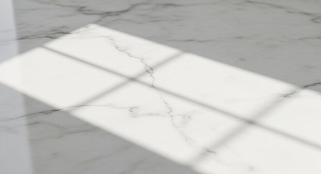 A close-up view of a white marble surface with gray veins and a window reflection