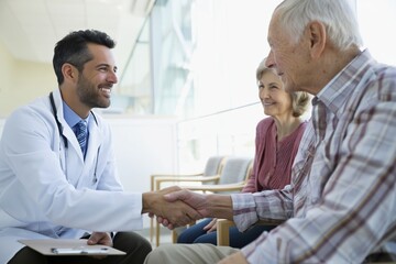 Obraz premium Doctor Greeting a Senior Couple with a Handshake in a Waiting Area