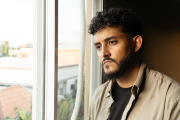 Fototapeta premium Man feeling lonely and reflecting by window