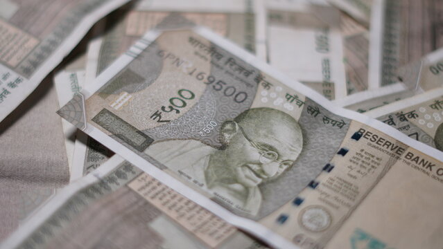 Pile of Indian Five Hundred Rupee Currency Notes on a Flat Surface. Scattered Indian Paper Currency Representing Wealth Investment and Economy. Indian Currency for Business and Banking Background.