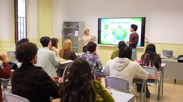 Diverse group of college students listening attentively to a teacher and a classmate presenting an environmental project about saving the planet