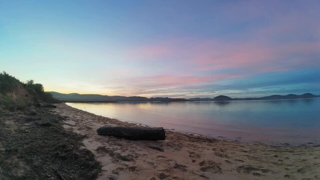 Beautiful colorful sunrise over a tranquil sea beach